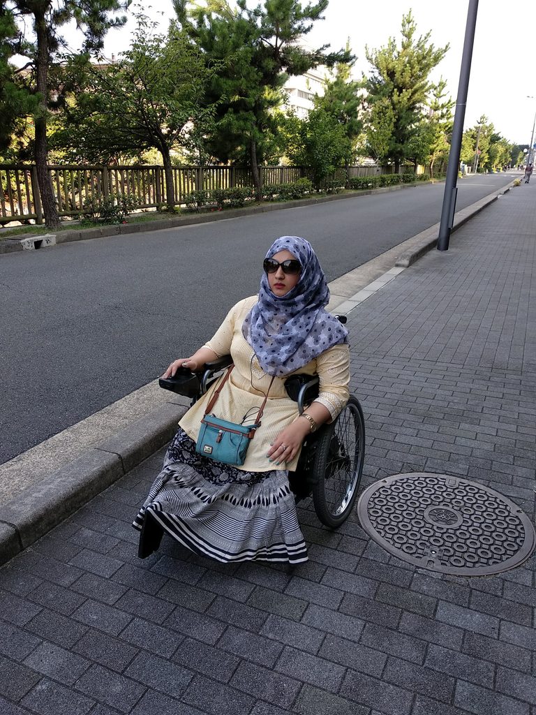 Tanzila Khan wheeling along a quiet street at sunrise in Kyoto, Japan