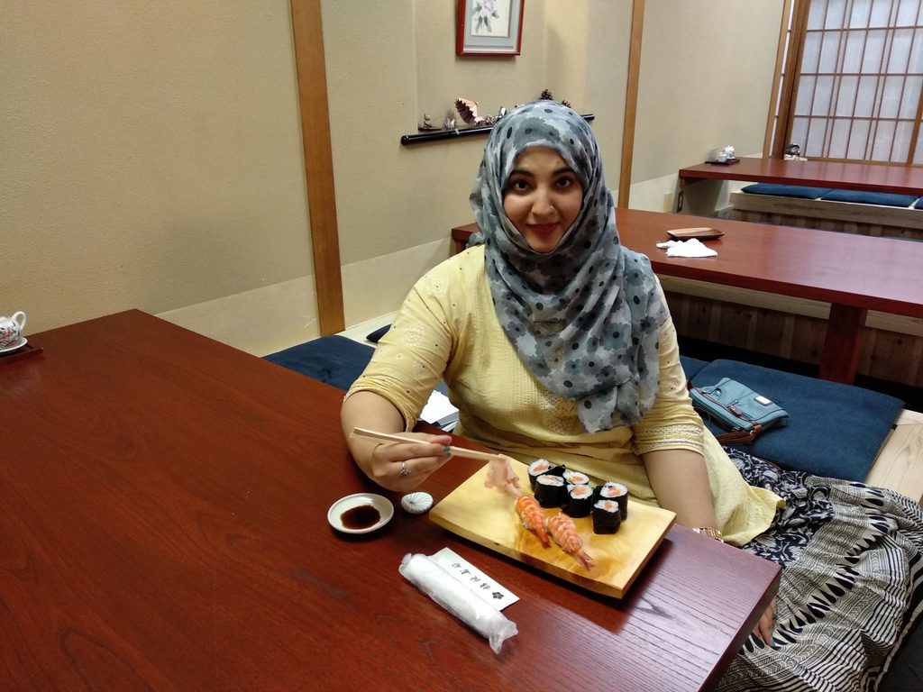 Tanzila Khan eating sushi at a small family-owned restaurant in Kyoto, Japan