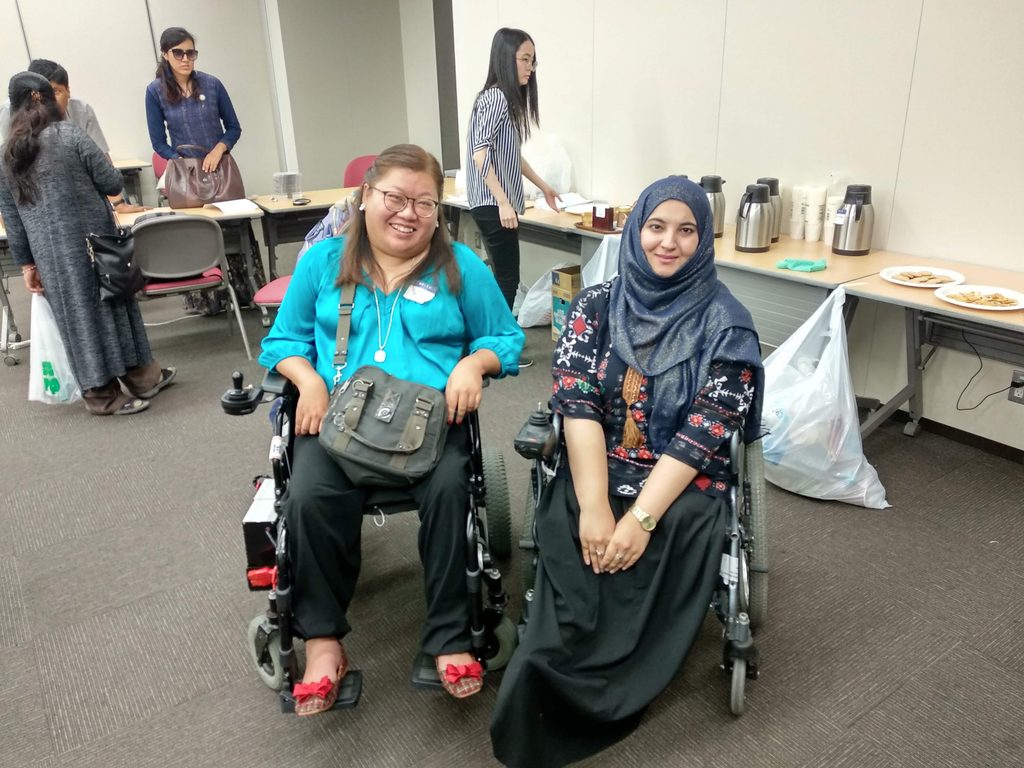 Tanzila Khan in her wheelchair with fellow attendees at the disability rights conference in Japan